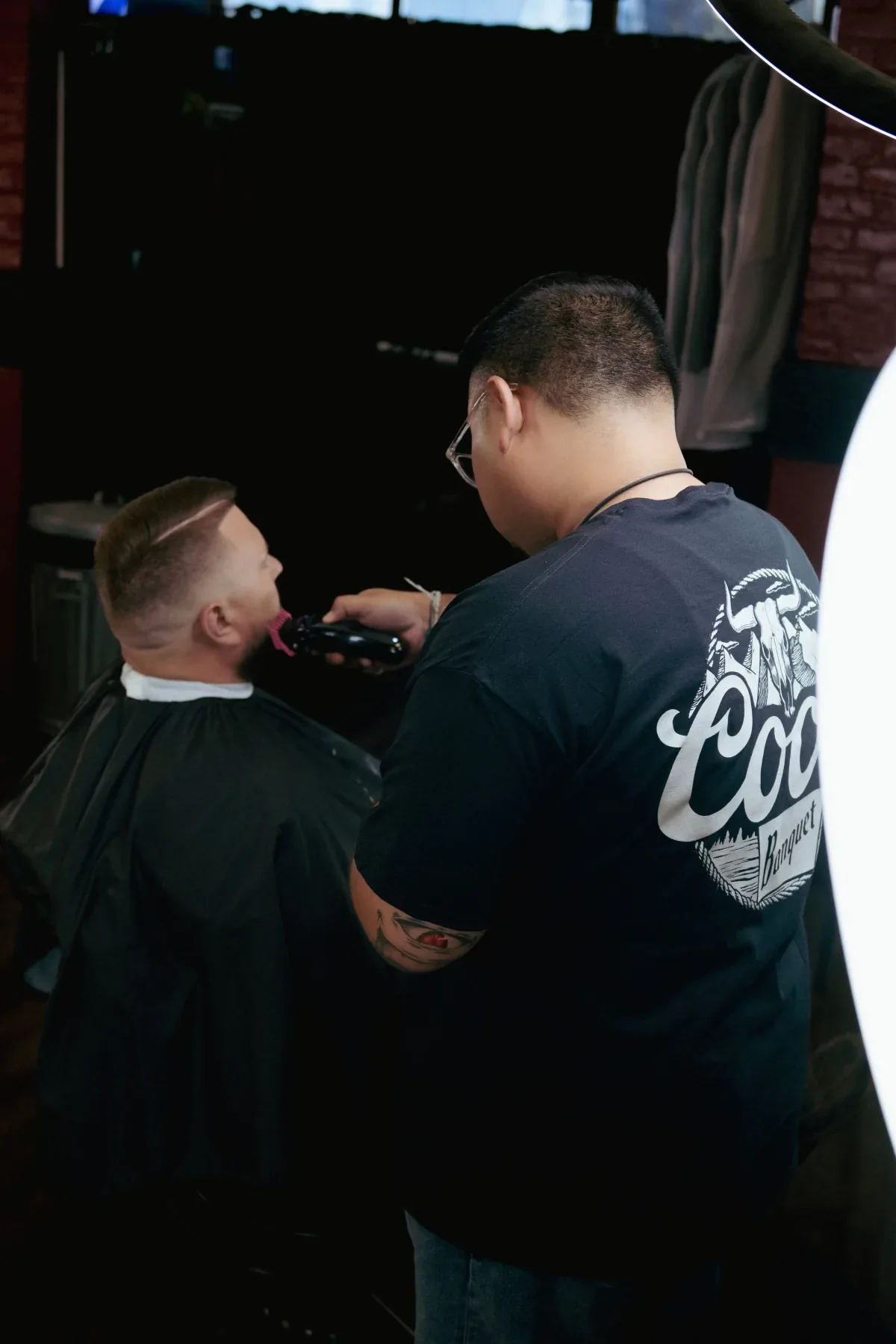 Professional barber giving a fresh fade haircut at Barber City Barbershop in Stockton CA