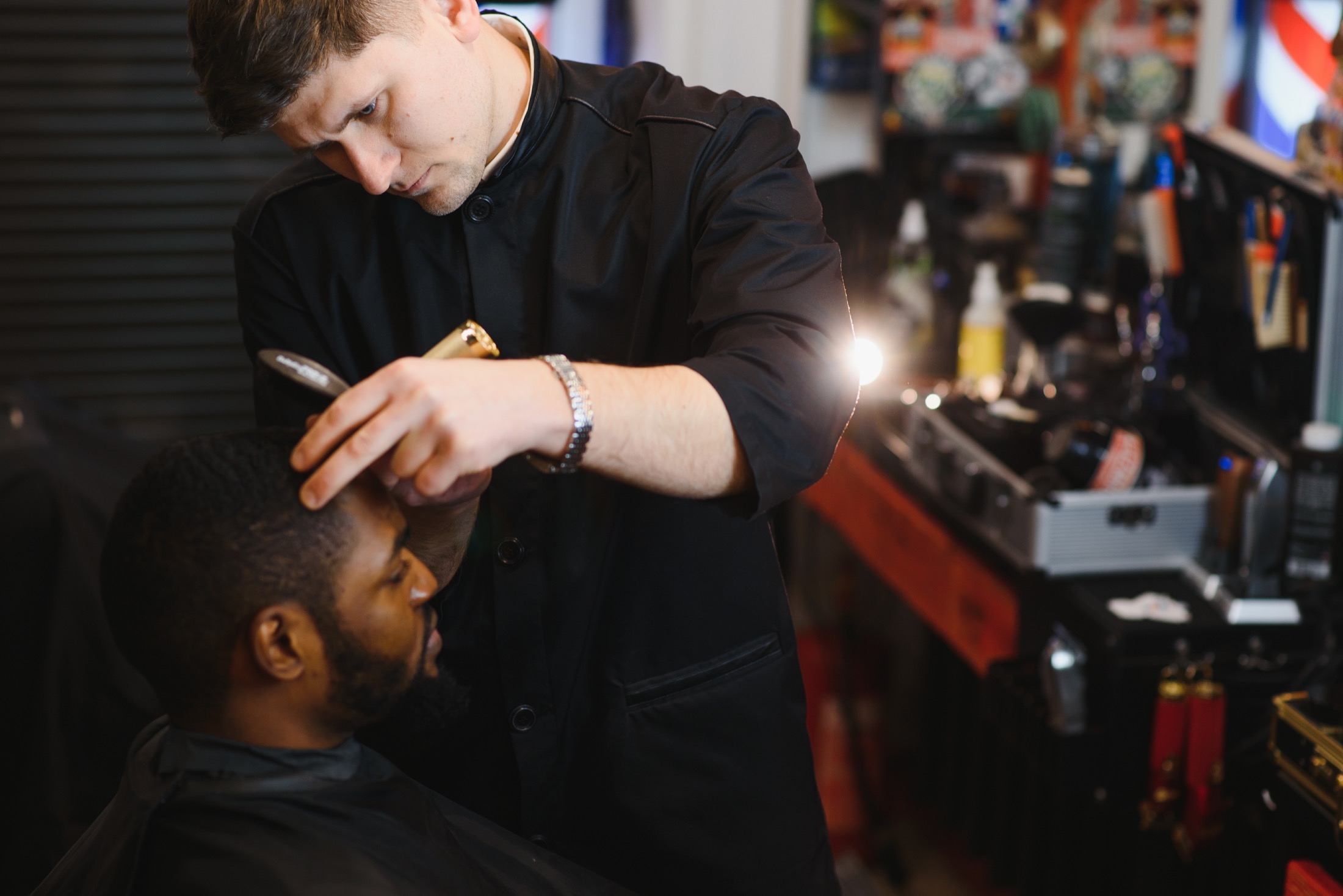 Barber completing a precise scissor haircut.